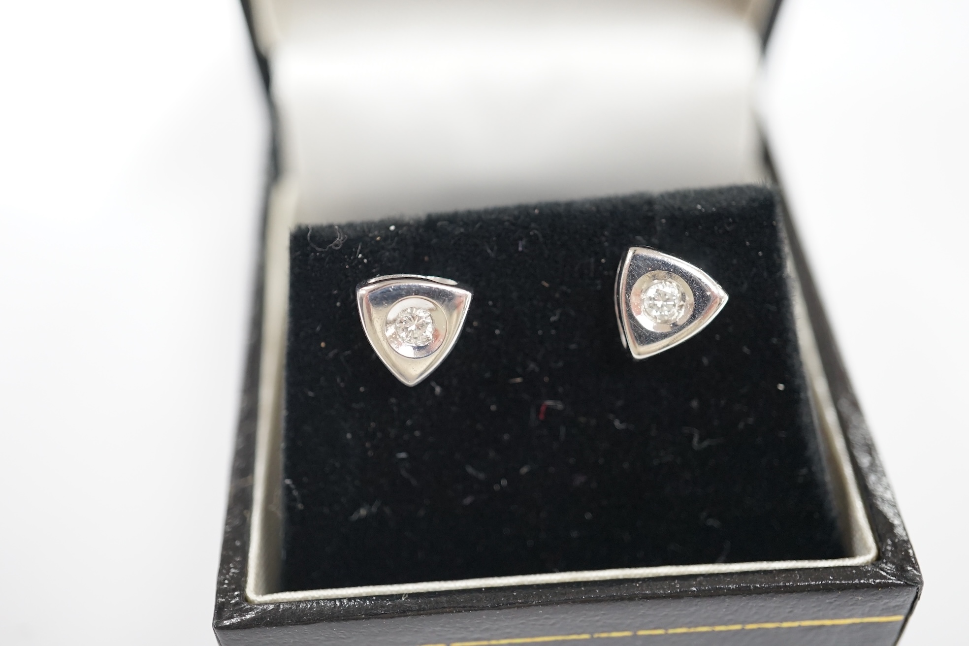 A modern pair of 18ct white gold and single stone diamond set ear studs, 6mm, gross weight 2.8 grams. Condition - fair to good